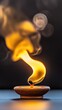 © Nart - A close-up view of a clay oil lamp with a glowing golden flame. Warm light and elongated shadows highlight the lamp's textured surface against a dark backdrop.