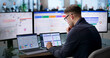 © Andrey Popov - Young Businessman Studies Sales Data On Laptop