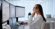 © Andrey Popov - Woman At Desk Updating Patient Records On Computer