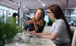 © Andrey Popov - Woman And Colleague Study City Maps On Laptop