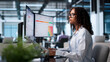 © Andrey Popov - Woman Evaluates Supplier Security Scores On Dual Screens