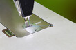 © cgdeaw - Sewing machine, showcasing garment production, textile manufacturing, tailoring, craftsmanship, fashion industry, and precision sewing, close-up