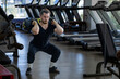 © Akarawut - Caucasian muscular body builder sport man is practice weight training on sandbag lunges for core muscle inside gym for exercising and hyrox workout concept