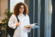 © Serhii - Young female medical student carrying books and backpack