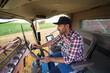 © Artcore Studio/Stocksy - A Farmer Inside a Combine Harvester