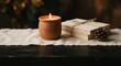 © Skyfe - Lit Terracotta Candle and Vintage Books on Linen, Cozy Autumn Hygge Lifestyle Concept for Seasonal Marketing