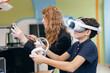 © Parilov - Boy testing virtual reality headset with instructor in classroom, Concept innovative education