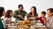 © Felippe Lopes - Multiethnic family enjoying a festive roast chicken dinner together laughing and celebrating at a wooden table