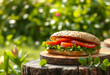 © Pixel-Shot - Fresh vegetarian sandwich with sliced tomatoes and green lettuce on a wooden board outdoors in natural light, the sandwich is placed on a tree stump outdoors
