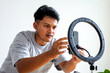 © Gatot - Young Content Creator Adjusting Smartphone and ring Light Before Recording