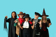 © Pixel-Shot - Cute happy children in different costumes dressed for Halloween party on blue background