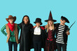© Pixel-Shot - Cute happy children in different costumes dressed for Halloween party on blue background