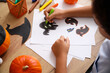 © Pixel-Shot - Teenage boy drawing for Halloween decorations at home, closeup