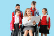 © Pixel-Shot - Mature teacher in wheelchair with little pupils using laptop on blue background