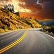 © Ja - A scenic highway winds through a mountainous landscape at sunset