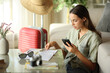© PheelingsMedia - Tourist checking paper guide and phone on vacation