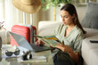 © PheelingsMedia - Tourist checking paper guide on vacation