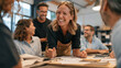 © CreativeArt - Happy business team meeting, smiling female leader engaging with colleagues, working on designs and creative ideas
