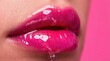 © Yauhen - Extreme close-up of vibrant pink glossy lips with clear liquid dripping against a pink background, highlighting beauty and cosmetic hydration.