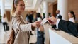 © OleksandrZastrozhnov - Businesswoman handing card to receptionist in hotel lobby