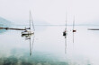 © Rechitan Sorin - Boat on Lake Como at the sunrise. Retro style photo. Sunset view of the lake in Lombardy. Domaso resort at Lake Como Italy.