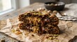 © Suriana - Delicious Chocolate Pistachio Baklava Stacked on Brown Paper.