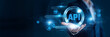 © Shevon - Businessman hand hold API and global networking data, integrating software platforms, enabling seamless connectivity, supporting cloud applications, improving automation.
