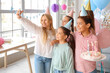 © Pixel-Shot - Cute little children with Birthday cake taking selfie at party