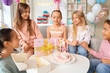 © Pixel-Shot - Cute little children in party hats celebrating Birthday at home