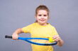 © Volodymyr - Child play tennis. Child holds tennis racket and tennis ball on isolated studio background. Sports training kid concept. Healthy kids lifestyle with tennis. Kids sport portrait.
