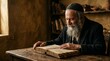 © xuxu - Elderly Jewish man with a long beard reading an old book at a wooden table in a traditional setting