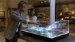 © Tanu - Two people interact with a digital display in a museum during a daytime visit, exploring artistic and technological features