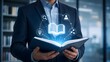 © Ridwan_DigitalGrid - Businessman holding an open book with glowing digital network icons representing e-learning online education and corporate knowledge transfer.