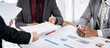 © Freedomz - Three men are sitting at a table with papers and pens