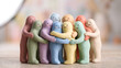 © Agung - Group of colorful clay figurines hugging each other to represent friendship, unity, diversity, and emotional support in a community
