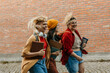 © La Famiglia - Diverse students laughing and running on college campus