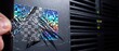 © Mdmomin - Hand peeling holographic security sticker showing void message from black server hardware to indicate tamper evidence and breach.