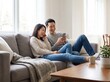© reza - Happy Young Asian Couple Sharing Earphones and Laughing While Using Smartphone on Sofa at Home