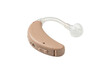 © qori - Beige behind the ear hearing aid device on solid black background