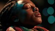 © AndiAzis - Young black girl with braided hair in colorful headwrap, eyes closed in serene moment with teal bokeh