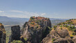© moryachka - Drone view of Great Meteoron Monastery built on top of massive rock formation in Meteora Greece for famous Eastern Orthodox landmark and tourism trip concept