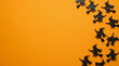 © Achraf - Halloween orange background with flying witch silhouettes along the right border, eerie copy space for spooky Halloween party decoration, magical horror backdrop and mysterious seasonal design