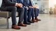 © ASyen - Corporate professionals in formal attire sit composedly, representing a lineup of ambitious talent ready for a new business challenge or opportunity