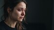© DhimasPratama - profile view of a crying woman showing deep sorrow and heartbreak in dark room