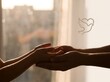 © Stefanus - Two silhouetted hands gently holding each other against soft warm backlit window light symbolizing peace with captures silhouettes two window floating dove