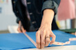 © Kawee - Close up of young woman working as fashion designer in tailor studio.