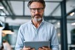 © ttonaorh - Business professional using digital tablet in modern office