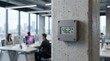 © Ronnayut - Leak prevention tech demonstrated by a digital wallmounted humidity sensor in a modern office tower with blurred computers.