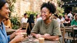 © Felippe Lopes - Diverse friends enjoying coffee and conversation at an outdoor cafe