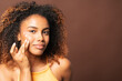 © Gonzalo Infiesta - Young black woman applying face cream